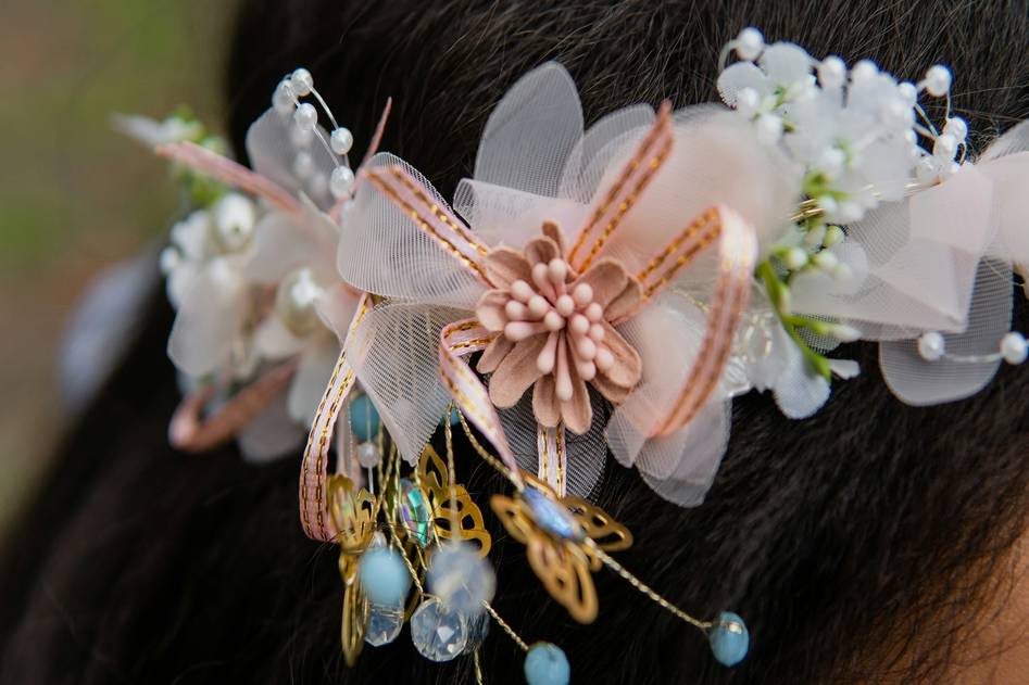 Delicate gold and pearl hair charms on styled wavy hair