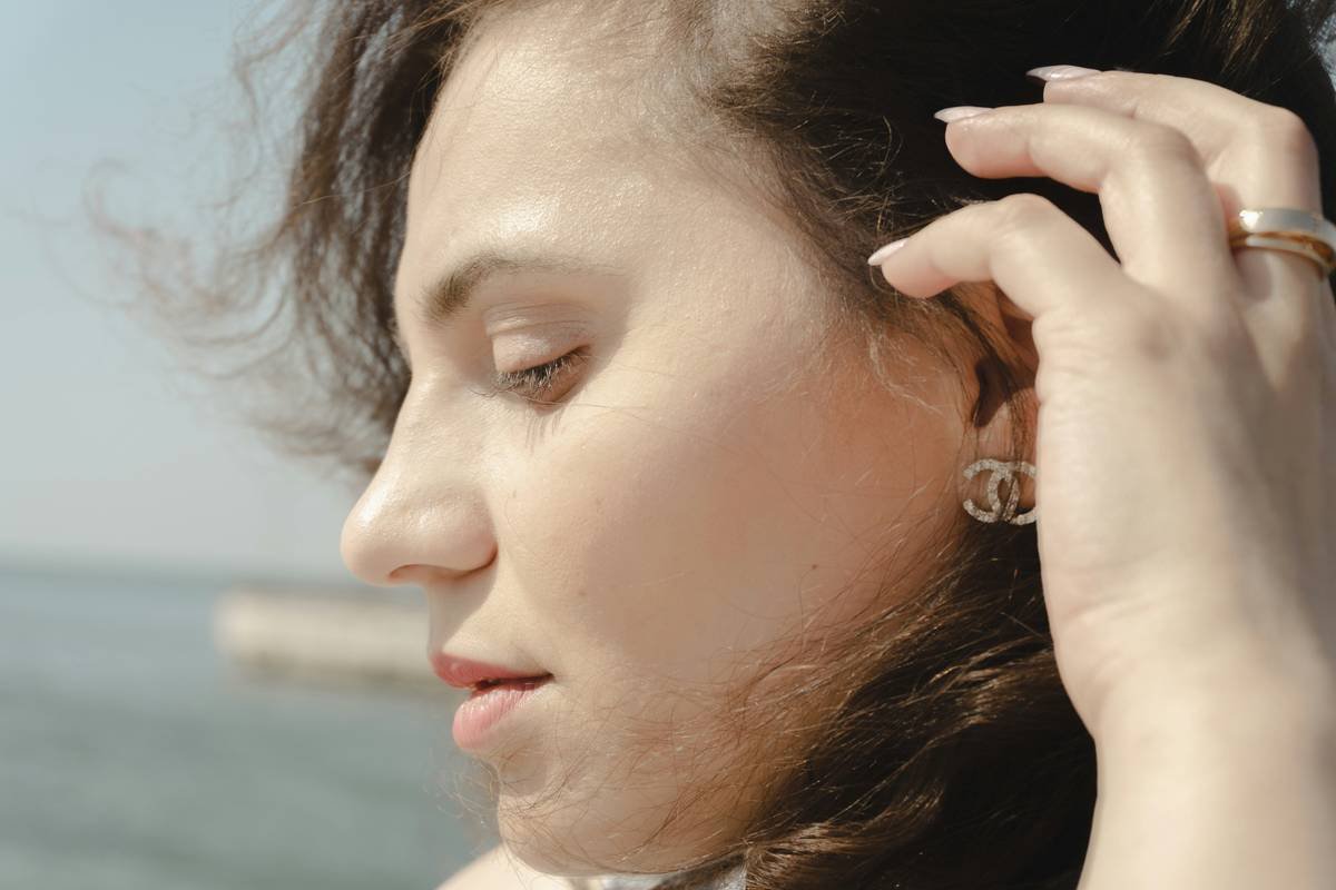 Close-up of charm extenders attached to fine hair strands with delicate star charms