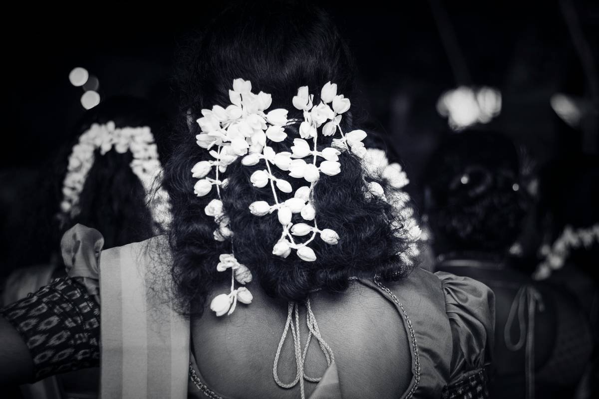 Close-up of professional floral crowns showing tension-wrapped wire technique on model's hair